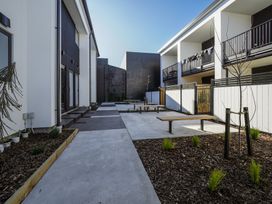 An outdoor area with benches and walkways at Central Crossing - Christchurch Holiday Home, Christchurch