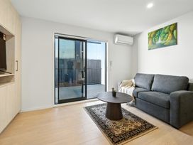 A living room with a sofa and coffee table at Central Crossing - Christchurch Holiday Home Christchurch