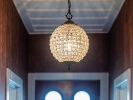 A chandelier in a hallway at Creed Cottage - Whitianga Holiday Home