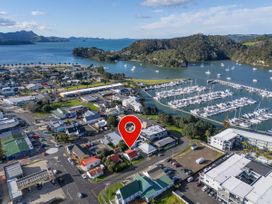 An aerial view of a town near water with a marina and numerous boats at Creed Cottage - Whitianga Holiday Home, Whitianga