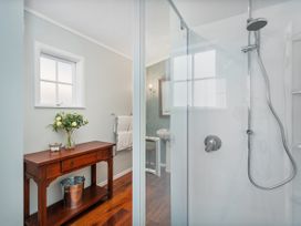 A bathroom featuring a shower and vanity at Creed Cottage - Whitianga Holiday Home Whitianga