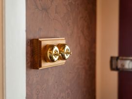 A light switch on a wall at Creed Cottage - Whitianga Holiday Home