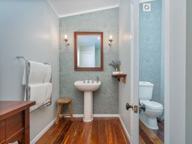 A bathroom with a sink and toilet at Creed Cottage - Whitianga Holiday Home in Whitianga