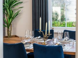 A dining table with chairs and glassware at Creed Cottage - Whitianga Holiday Home Whitianga
