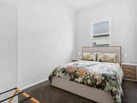 A bedroom with a bed and nightstands at Arbor Villa - Greytown Holiday Home in Greytown
