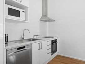 A kitchen with a sink, stove, microwave, and oven at Arbor Villa - Greytown Holiday Home Greytown