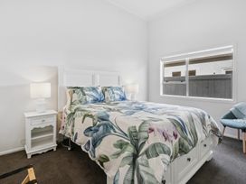 A bedroom with a bed and nightstand at Arbor Villa - Greytown