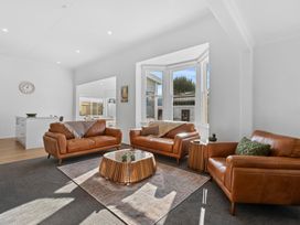 A living room with leather sofas and a coffee table at Arbor Villa - Greytown Holiday Home, Greytown