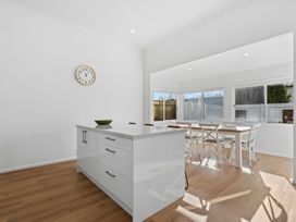 A kitchen with an island and dining area at Arbor Villa - Greytown Holiday Home Greytown