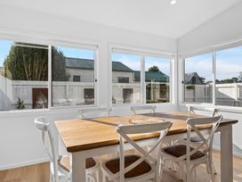 A dining room with a wooden table and chairs at Arbor Villa - Greytown
