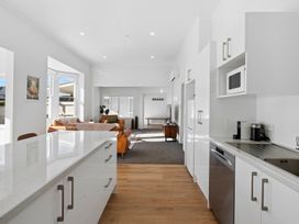 A kitchen featuring appliances and seating area at Arbor Villa - Greytown Holiday Home in Greytown