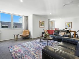 A living room with a sofa and a coffee table at Downtown Haven - Christchurch Holiday Apartment Christchurch