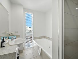 A bathroom with a bathtub and sink at Downtown Haven - Christchurch Holiday Apartment, Christchurch