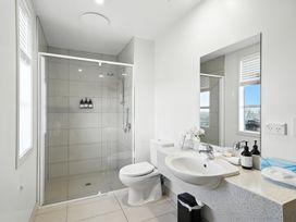 A bathroom with shower, toilet, and sink at Downtown Haven - Christchurch Holiday Apartment Christchurch