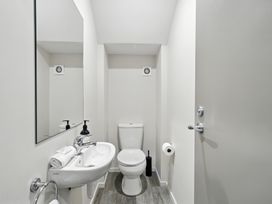 A bathroom with a toilet and sink at Downtown Haven - Christchurch Holiday Apartment in Christchurch