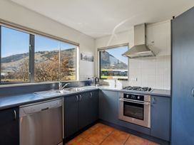 A kitchen with sink and stove at Vista Vale - Wanaka Holiday Home