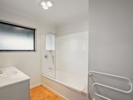 A bathroom with a bathtub and shower at Vista Vale - Wanaka Holiday Home
