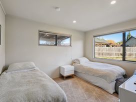A bedroom with two beds and a window at Vista Vale - Wanaka Holiday Home