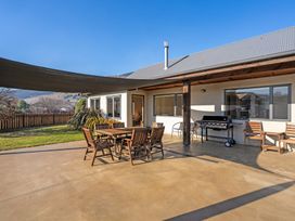An outdoor area with seating and a barbecue at Vista Vale - Wanaka Holiday Home