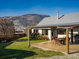An outdoor area with a table and chairs at Vista Vale - Wanaka Holiday Home