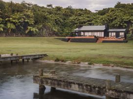 A house with a deck by the water at Lake Rotoiti in Rotorua