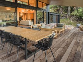 An outdoor dining area with table and chairs at Lake Rotoiti in Rotorua