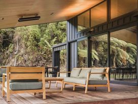 An outdoor seating area with furniture at Lake Rotoiti in Rotorua