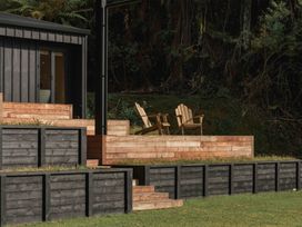 An outdoor space with a house and wooden deck at Lake Rotoiti in Rotorua