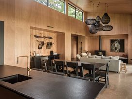 A living room with a kitchen island and dining area at Lake Rotoiti, Rotorua
