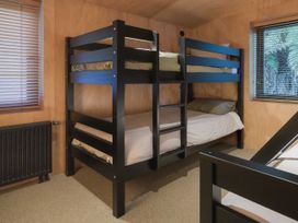 A bedroom with a bunk bed and a window at Lake Rotoiti in Rotorua
