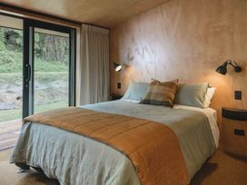 A bedroom with a bed and window at Lake Rotoiti in Rotorua