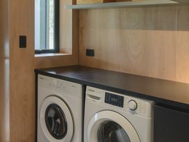 A laundry room with a washing machine and dryer at Lakefront Luxury at Okere Falls Lake Rotoiti