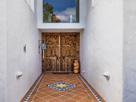 An entrance with wooden doors and decorative tiles at Seabreeze Sanctuary - Paihia Holiday Home