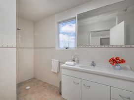 A bathroom with shower and sink at Seabreeze Sanctuary - Paihia Holiday Home