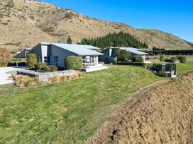 A house surrounded by grass and trees at Tussock Cottage - Canterbury Holiday Home, Canterbury