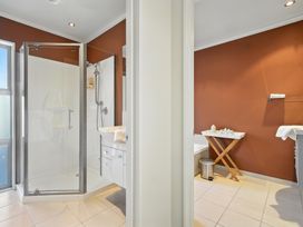 A bathroom with shower and bathtub at Tussock Cottage - Canterbury Holiday Home Canterbury