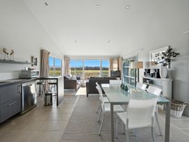 A living room with sofa and dining area at Flax Cottage - Canterbury Holiday Home in Canterbury