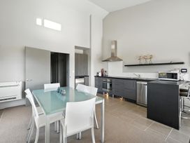 A kitchen with a dining table and appliances at Flax Cottage - Canterbury Holiday Home in Canterbury