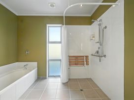A bathroom with a bathtub and shower at Flax Cottage - Canterbury Holiday Home Canterbury