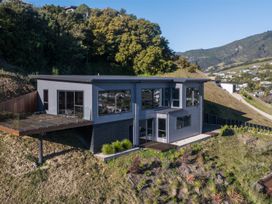 A modern house with a deck and landscaping at Nelson Holiday home in Nelson