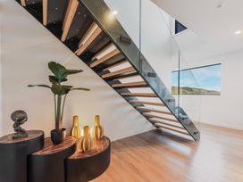 A staircase with a potted plant and decorative vases at Nelson Holiday home in Nelson