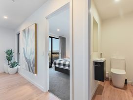 A bathroom and bedroom area with a sink and toilet at Nelson Holiday home in Nelson