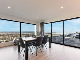 A dining room with a table and chairs at Nelson Holiday home in Nelson