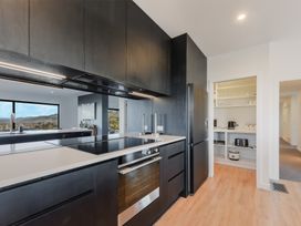 A kitchen with appliances and cabinets at Nelson Holiday home in Nelson