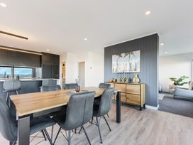 A dining room with a wooden table and chairs at Nelson Holiday home in Nelson