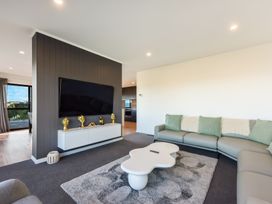 A living room with a television and sofa at Nelson Holiday home in Nelson