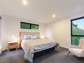 A bedroom with a bed and a nightstand at Nelson Holiday home in Nelson