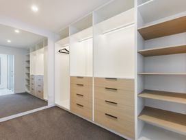 A dressing room with shelves and drawers at Nelson Holiday home in Nelson