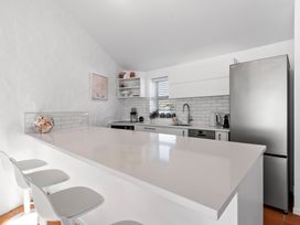 A kitchen with a countertop and appliances at Sea Breeze - Orewa Oceanside Apartments in Orewa