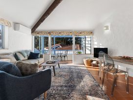 A living room with a sofa and coffee table at Sea Breeze - Orewa Oceanside Apartments in Orewa